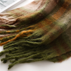 Macro shot of colorful thick cashmere scarf with long tassels and gradient plaid texture