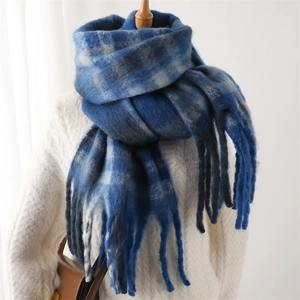 Detail of blue and grey plaid scarf with long soft fringes and thick cashmere-like texture