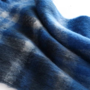 Macro shot of fluffy blue and white plaid cashmere-like scarf with soft mohair texture