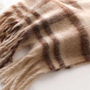 Close-up of beige plaid cashmere scarf with soft brushed texture and thick fringe