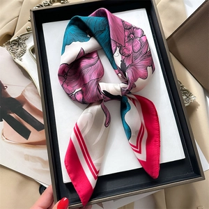 French retro satin scarf with peony floral print and bold magenta border on a tray