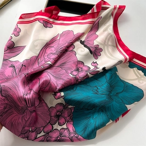 Detail of silk scarf with pink peonies and butterfly print and striped edges