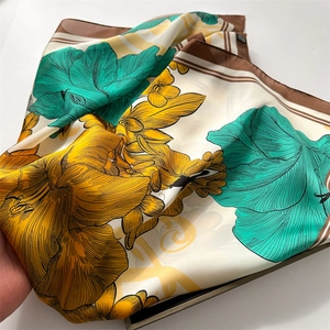 Detail of silk-like satin square scarf featuring vintage peony floral prints in beige and yellow