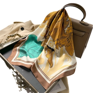 French vintage silk scarf with peony floral print draped over a stylish handbag