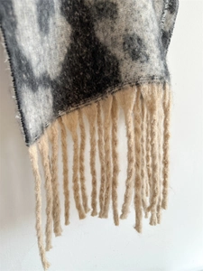 Nahaufnahme des dicken Leoparden-Jacquard-Schals mit beigen Fransen und weicher Textur