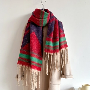 Detail of multi-color striped scarf with soft tassels on beige coat for autumn