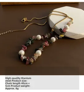 Detail of colorful stone and pearl necklace showing titanium steel chain and length