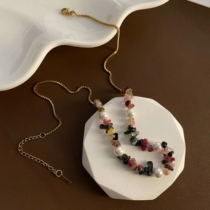 Bohemian style necklace with colorful natural gemstones and white pearls on golden chain