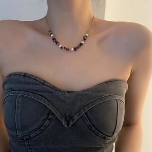 Agate and crushed stone beaded necklace with pearls on a model at the collarbone