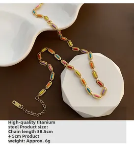 Detailed shot of 18K gold plated steel necklace with colorful enamel links and lobster clasp
