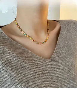 Detail of colorful enamel link necklace in titanium steel worn by a model