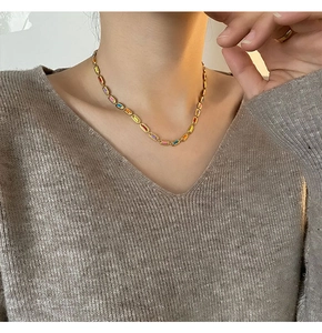 Colorful enamel link necklace worn on model featuring rainbow-toned rectangular charms