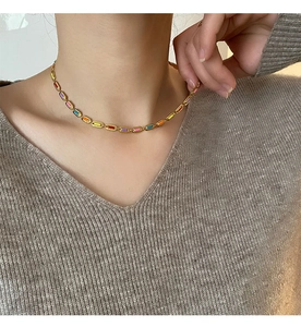 Close-up of colorful enamel rectangular links on a gold-plated stainless steel necklace
