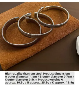 Detailed view of three titanium steel elastic arm cuffs with different diameter sizes