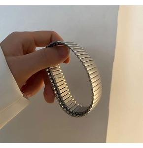 Close-up of adjustable stainless steel stretch bracelet showing minimalist metal links