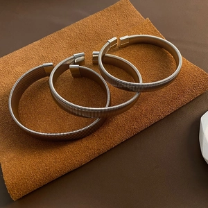Three-piece stackable titanium steel spring bracelets with polished silver finish and C-opening