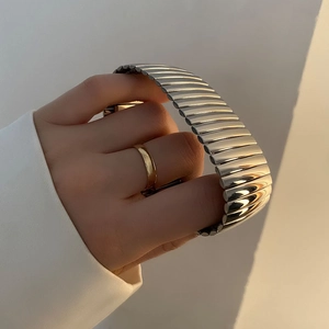 Polished silver stainless steel expansion watch band with minimalist industrial design
