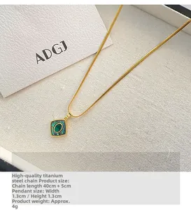 Close-up of a square green abalone shell pendant on a gold titanium steel chain