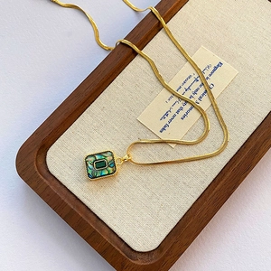 Chaîne serpent dorée vintage avec pendentif gemme verte et nacre d'abalone