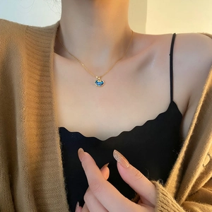 Elegant gold chain necklace with blue abalone shell ruyi lock pendant on model neck