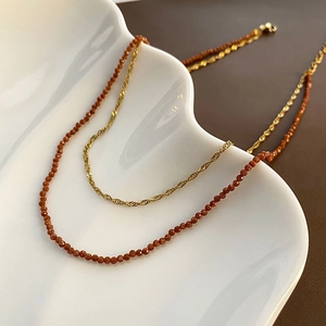 Double-layered natural orange garnet necklace with golden chain and sparkling beads