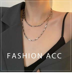 Detail of silver double-layer necklace with geometric rectangular tubes and layered look