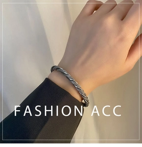 Macro detail of twisted metal rope design on a vintage stainless steel open cuff bracelet