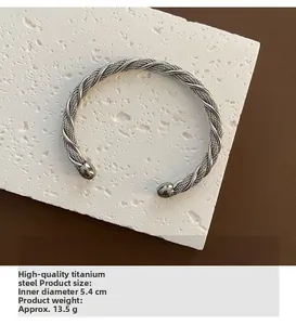 Detailed view of silver twisted cable cuff bangle with dimensions and specs