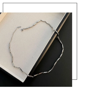 Detailed shot of silver geometric chain necklace with lobster clasp and adjustable extension