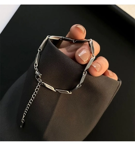 Macro view of minimalist silver geometric titanium steel link necklace with lobster clasp