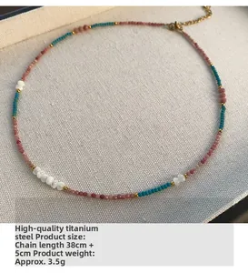 Macro detail of natural stone beaded necklace with gold titanium steel clasp and beads