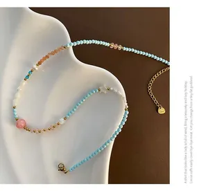 Detailed close-up of handmade beaded necklace with star charm on white ceramic tray
