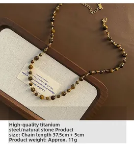 Detail of tiger eye bead necklace with titanium steel lobster clasp and extension chain