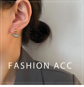Macro detail of elegant lotus flower earrings with gold finish and white petals