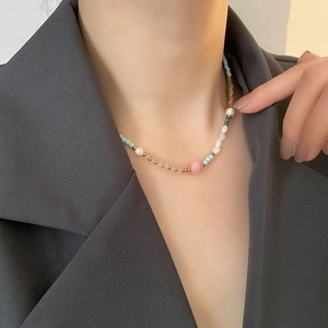 Titanium steel necklace with strawberry quartz, pearls and lucky star beads on a model
