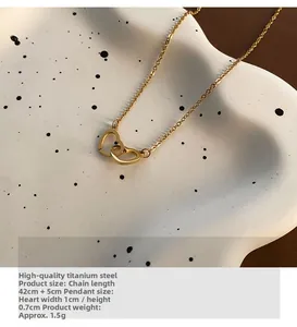 Close-up of golden interlocking heart pendant on titanium steel necklace with size details