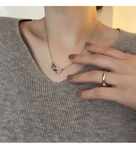 Close-up of interlocking heart pendants on a titanium steel necklace for women