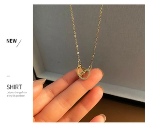 Detailed macro view of interlocking double heart pendants on a fine gold chain necklace