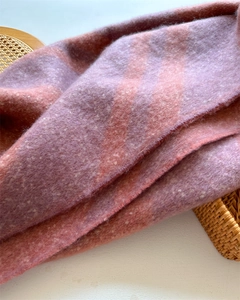 Close-up of thick pink and purple fuzzy knit scarf texture with warm wool-like fiber detail