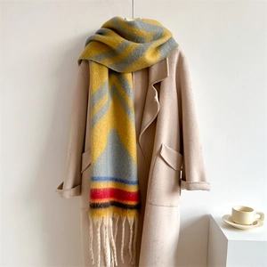 Close-up of thick winter scarf with vibrant color-block pattern and long tassels