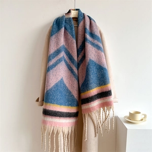 Close-up of geometric knit scarf with colorful chevron patterns and long fringe tassels