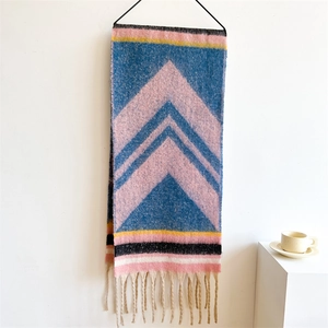 Detail of colorful geometric knit scarf with soft cashmere feel and fringe tassels