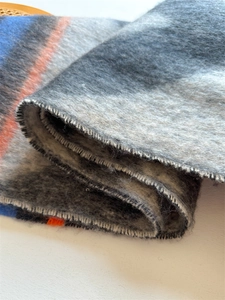 Close-up of thick striped boucle scarf showing soft mohair texture and vibrant colors