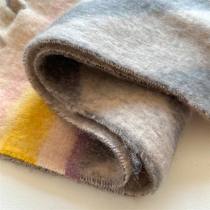 Macro detail of thick pastel color block scarf showing the soft fuzzy brushed texture