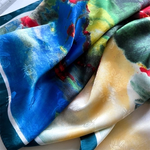 Macro view of silk scarf with lotus pond pattern and detailed dragonfly jacquard texture