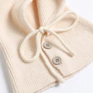 Detail of ribbed knit texture on cream Balaclava scarf with drawstring and buttons