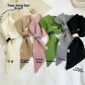 Flat lay of soft knitted neck scarves in assorted solid and dual-tone colors with H label
