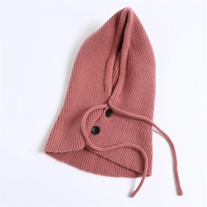 Detail of pink knitted balaclava showing ribbed texture, buttons, and drawstrings