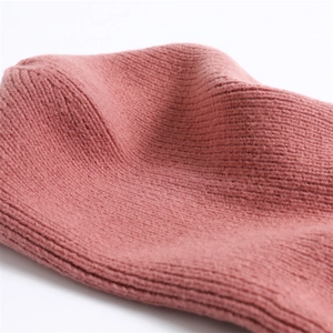 Close-up of pink ribbed knit texture on balaclava scarf showing soft woolen yarn details