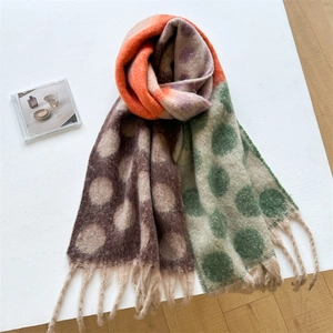 Detailed texture of thick multicolor polka dot scarf with soft tassel fringe finish